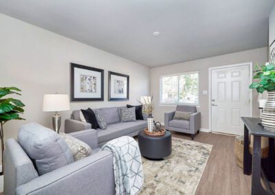 A well-designed kitchen with pristine white cabinets and chic black appliances, offering a striking contrast in decor.